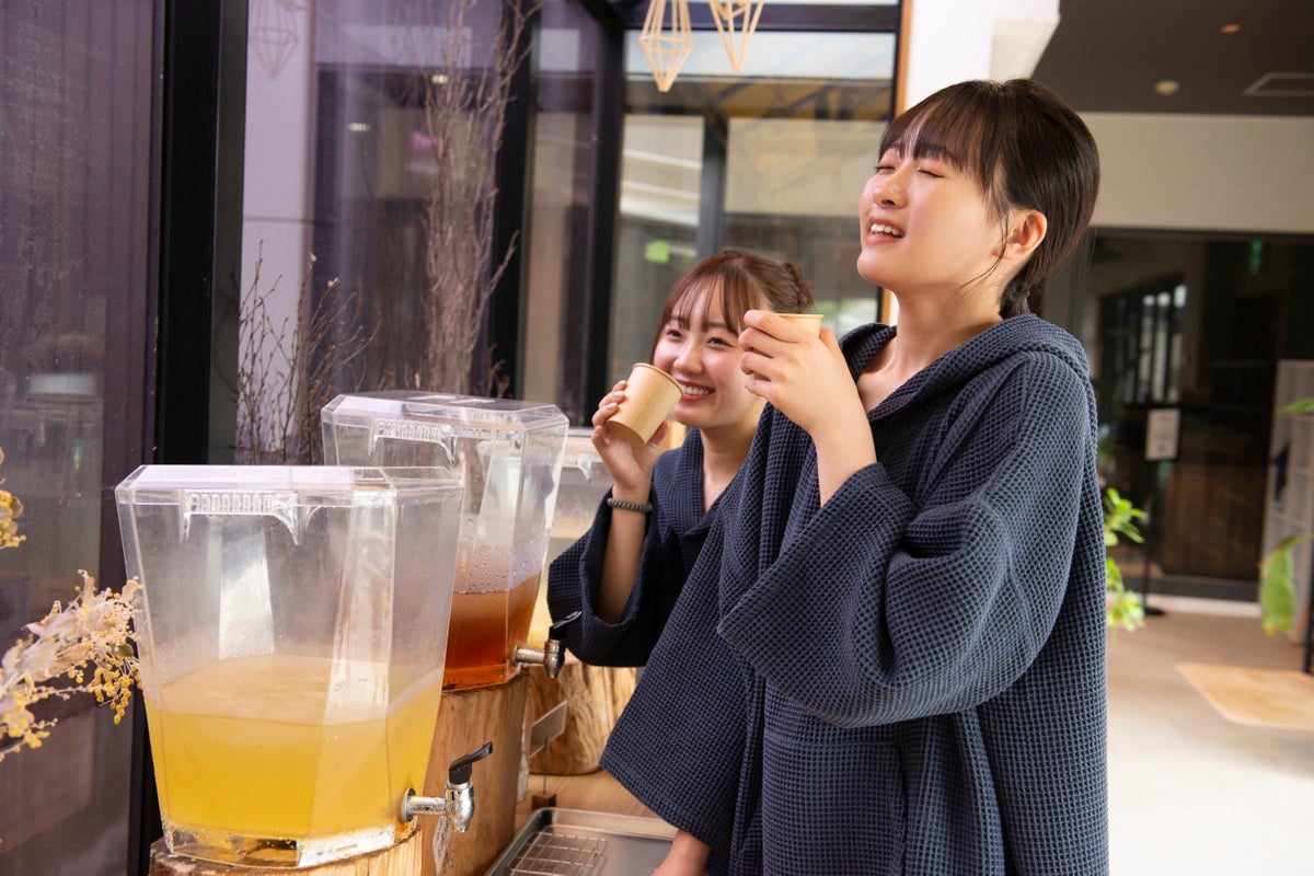 専用着を着てドリンクサーバーを利用する来場者